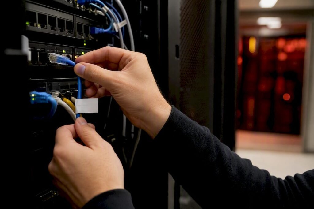 Hands unplugging network cable to stop phishing