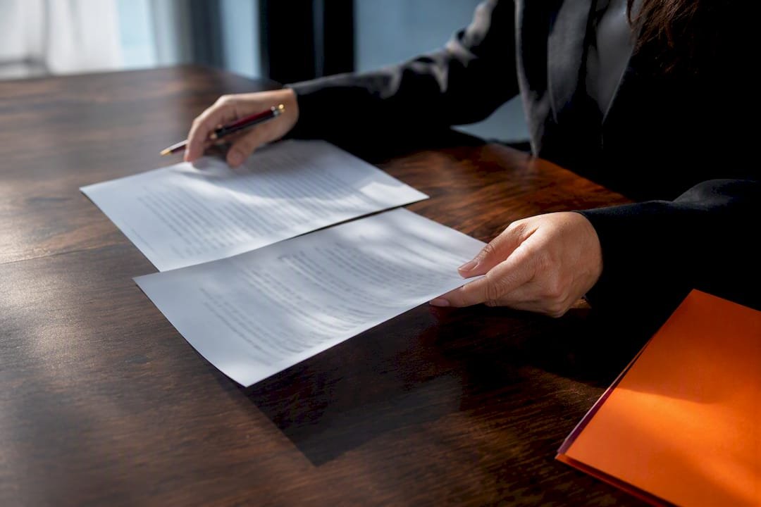 Hands reviewing a HIPAA agreement