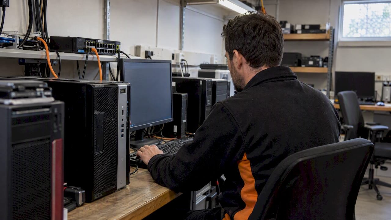 Technician testing a software patch deployment
